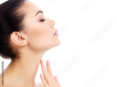 Fotografía Young female touches her neck, white background