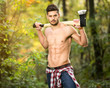 Sexy lumberjack in forest