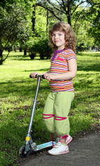 Wall Mural - little girl with scooter in park