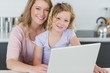 © WavebreakmediaMicro - Mother and daughter with laptop in kitchen