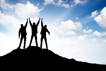 Wall Mural - silhouette of a team on the mountain top. active life concept
