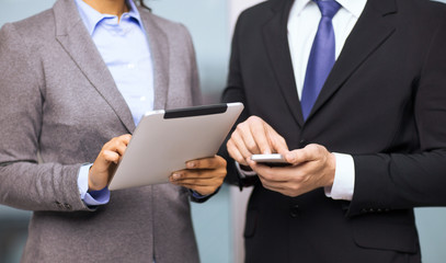 Wall Mural - two businesspeople with smartphone and tablet pc