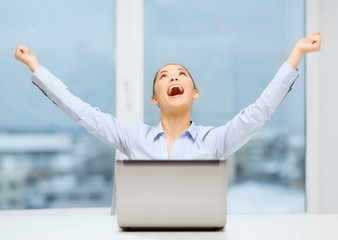 screaming businesswoman with laptop in office