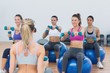© WavebreakMediaMicro - Fit class exercising with dumbbells on fitness balls