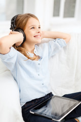 Poster - girl with tablet pc and headphones at home