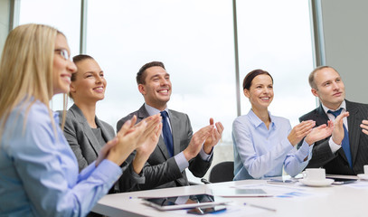 Canvas Print - business team with laptop clapping hands