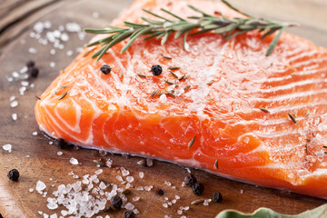 Wall Mural - Salmon filet on a wooden carving board.