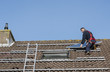 © Chris Willemsen - man putting the solar panel on the roof
