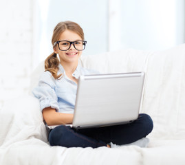 Poster - smiling girl in specs with laptop computer at home