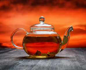 Canvas Print - Teapot of fresh tea on sky background