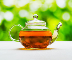 Wall Mural - Teapot of fresh tea on natural background