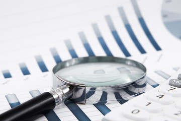 magnifying glass on the business report