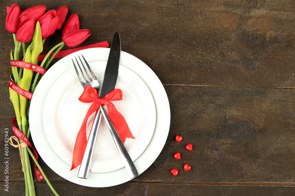 Romantic holiday table setting, on wooden background