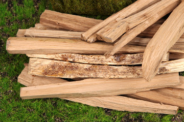 Stack of firewood on grass close up