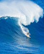 © EpicStockMedia - Surfer riding giant wave