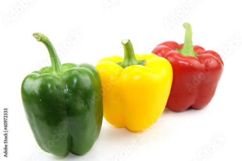 Photographie trio de poivrons rouge, jaune et vert sur fond blanc