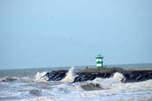 Lighthouse On Rocks In Sea