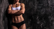 © Nobilior - Muscled woman against a grunge background