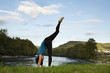 © MariaBobrova - Active woman practicing yoga outdoor.