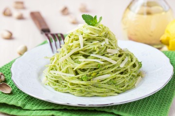 Italian green pasta spaghetti with pesto green peas, mint