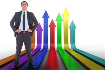 Poster - Composite image of serious businessman with hands on hips