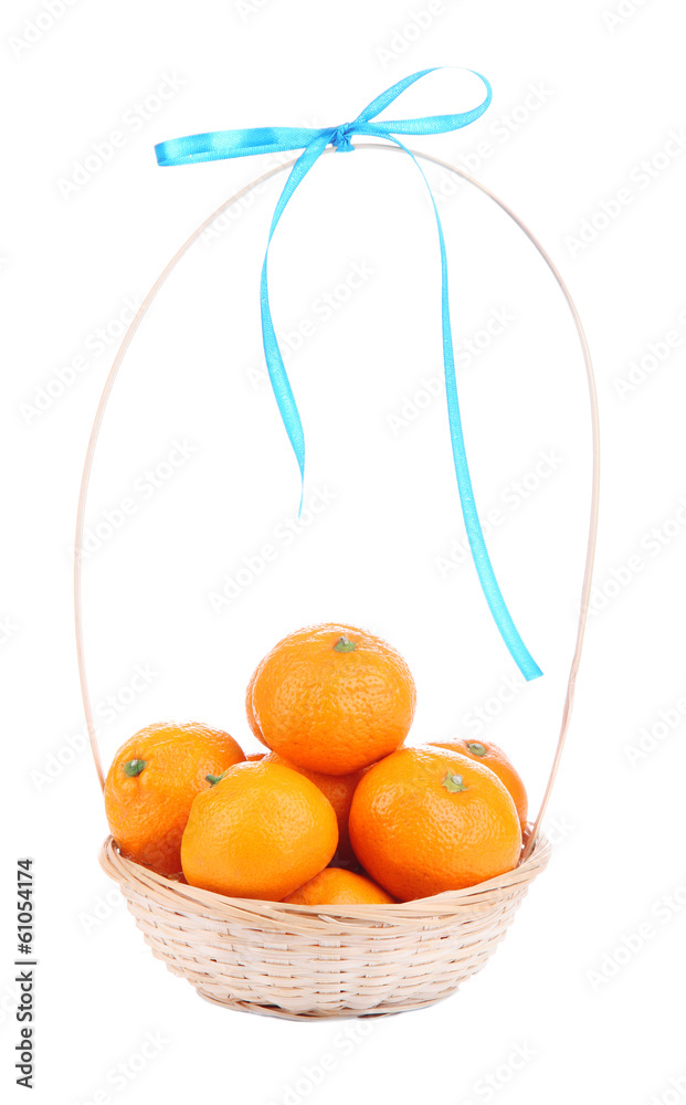 Ripe sweet tangerines in wicker basket, isolated on white