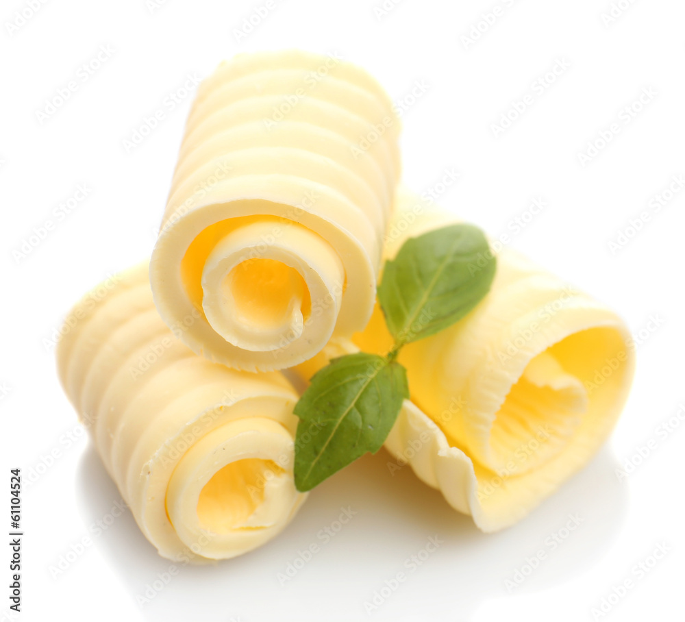 Curls of fresh butter with basil, isolated on white - obrazy, fototapety, plakaty 