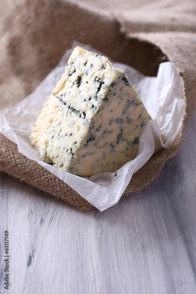 Tasty blue cheese, on wooden table