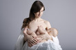 © Aliaksei Lasevich - Mother breast feeding her infant studio shot