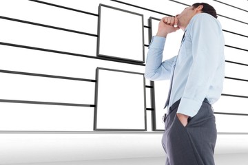 Poster - Composite image of thoughtful businessman with hand on chin