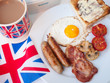 Bacon and eggs with cup of tea, toast and british flag