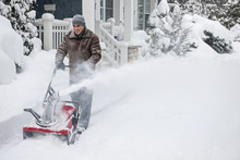 Man Clearing Driveway With Snowblower