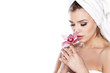 © vladimirfloyd - woman with a towel on her head enjoying the scent of orchids