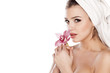 © vladimirfloyd - woman with a towel on her head enjoying the scent of orchids