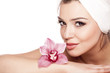 © vladimirfloyd - woman with a towel on her head enjoying the scent of orchids