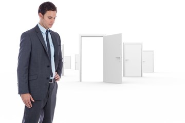 Poster - Composite image of serious businessman with hand on hip