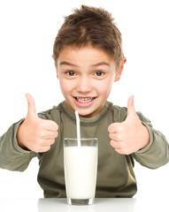 Wall Mural - Cute boy with a glass of milk