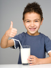 Wall Mural - Cute boy with a glass of milk