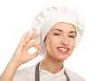 © shefkate - Attractive cook woman showing ok over white background.