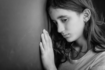 Grunge black and white portrait of a sad teenage girl