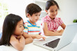 © Monkey Business - Three Asian Children Using Laptop At Home