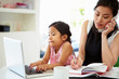© Monkey Business - Busy Mother Working From Home With Daughter