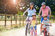 © Monkey Business - Asian Family On Cycle Ride In Countryside