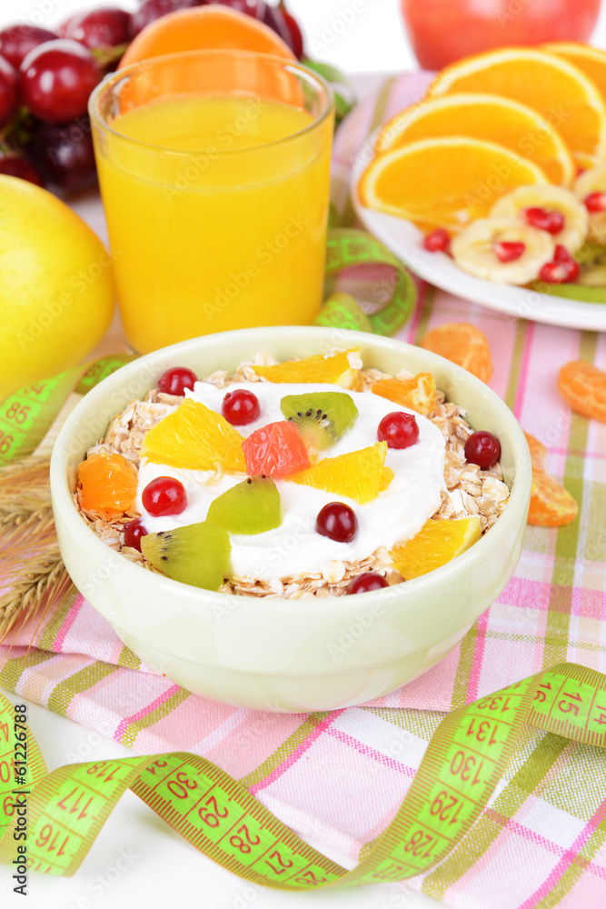 Delicious oatmeal with fruit in bowl on table close-up