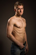 © Demian - Strong athletic man on dark background