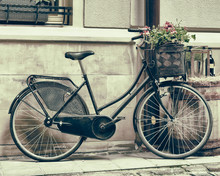 Vintage Stylized Photo Of Old Bicycle Carrying Flowers