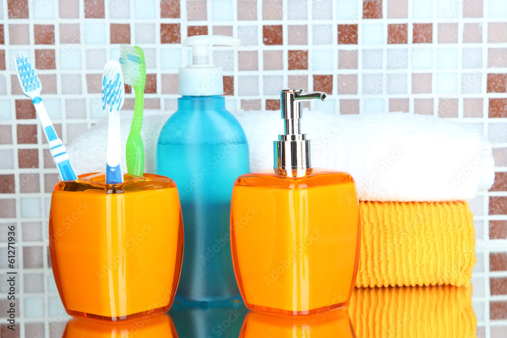 Cosmetics and bath accessories on mosaic tiles background