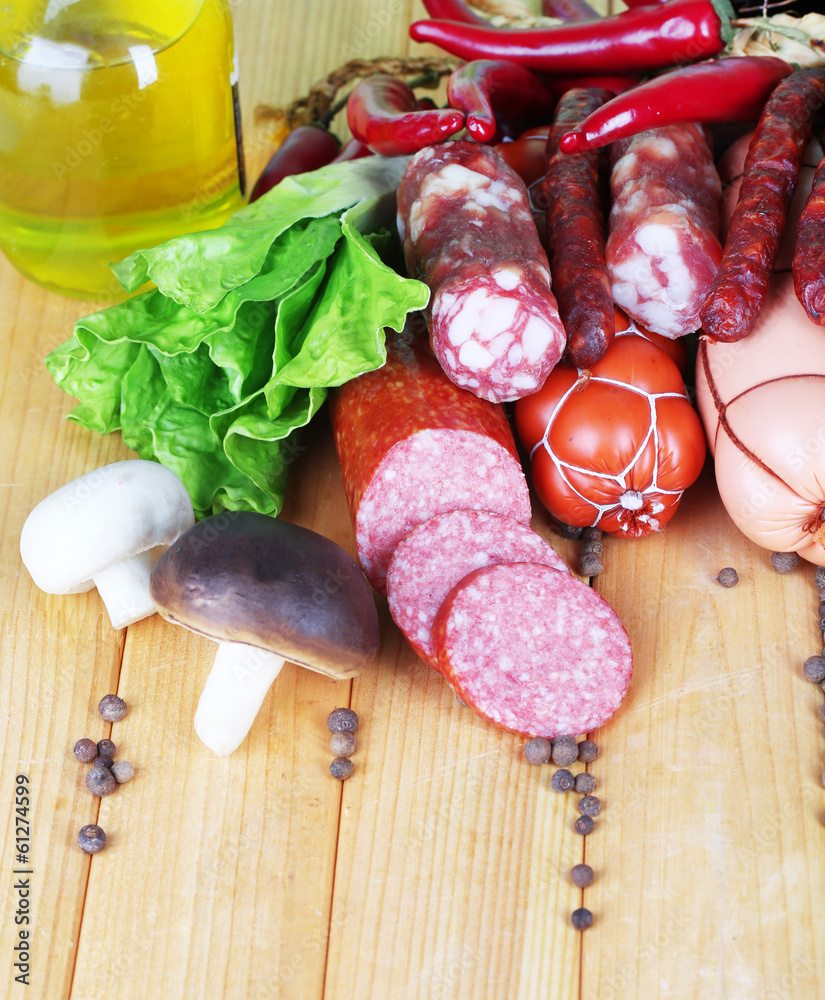 Different sausages on wooden table close-up