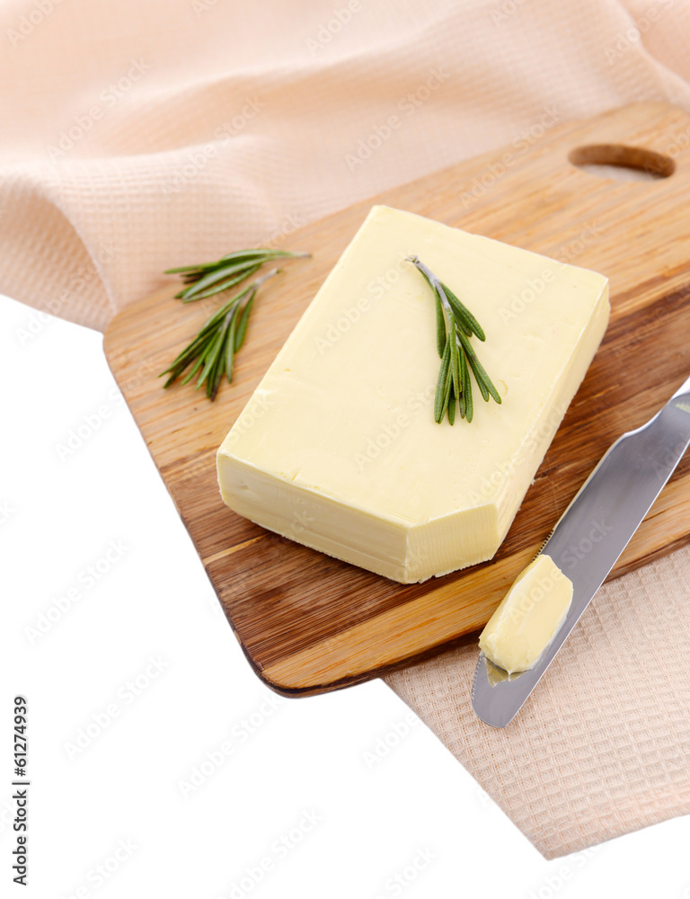 Tasty butter on wooden cutting board, isolated on white
