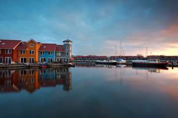 Fototapete - sunrise over marina with buildings and boats